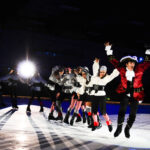 A group of people in costumes on an ice rink.