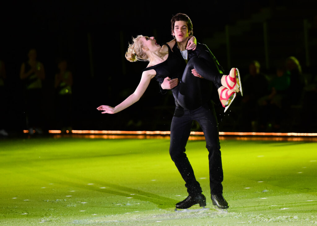 A man and a woman on an ice skating rink.