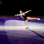 mirai nagasu in black dress performing on the ice