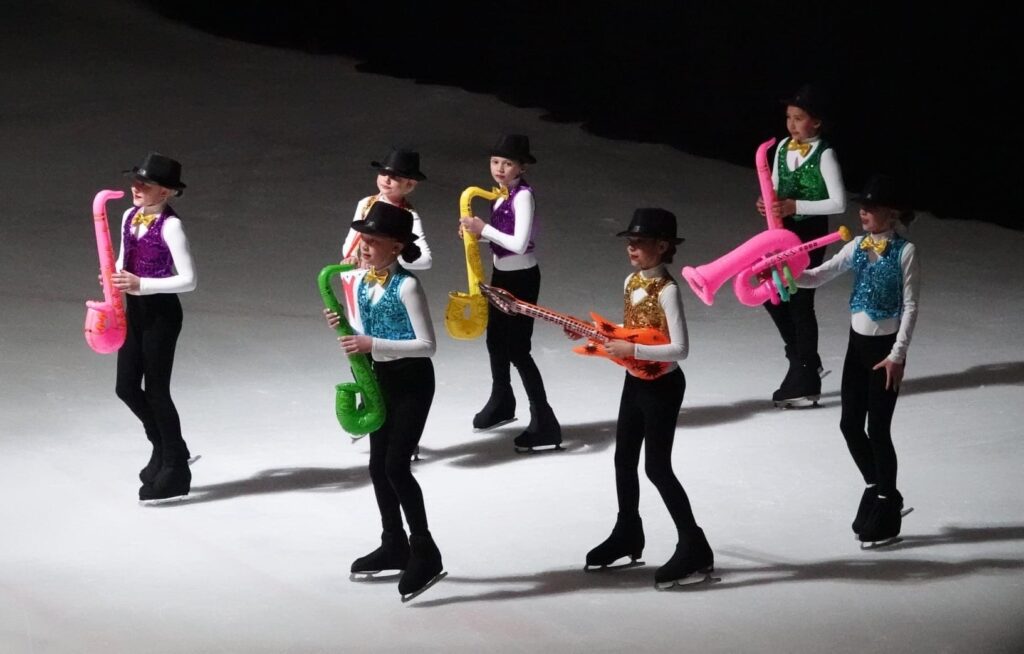 A long shot of the kids playing instruments on ice