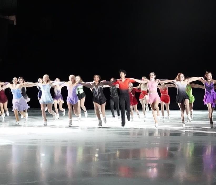 A long shot of the girls performing on the ice