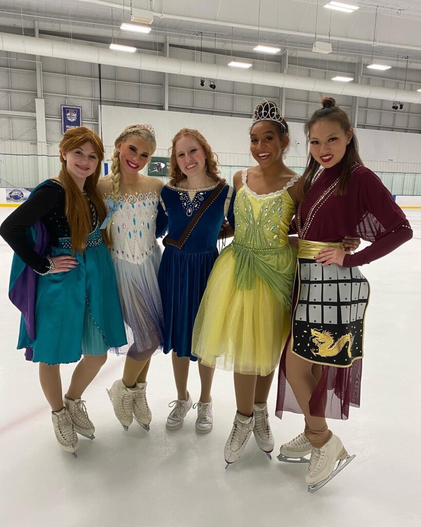 Young girls in colorful frocks standing on the ice