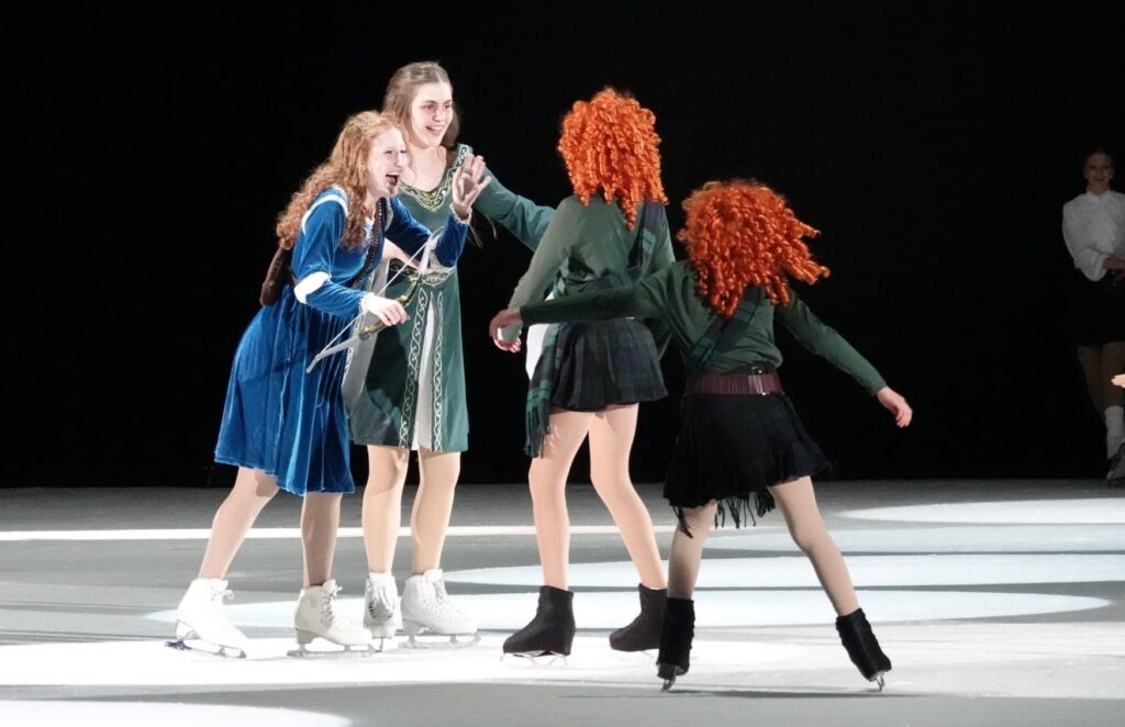 Four girls performing on the ice stage