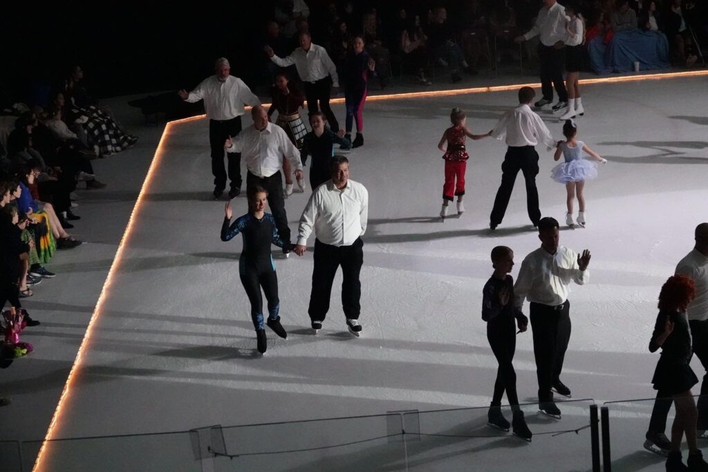 Kids with their fathers walking on the ice
