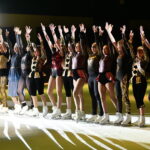 A group of women on ice skates posing for the camera.