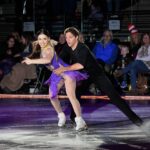 Couple skating in purple fringe costume