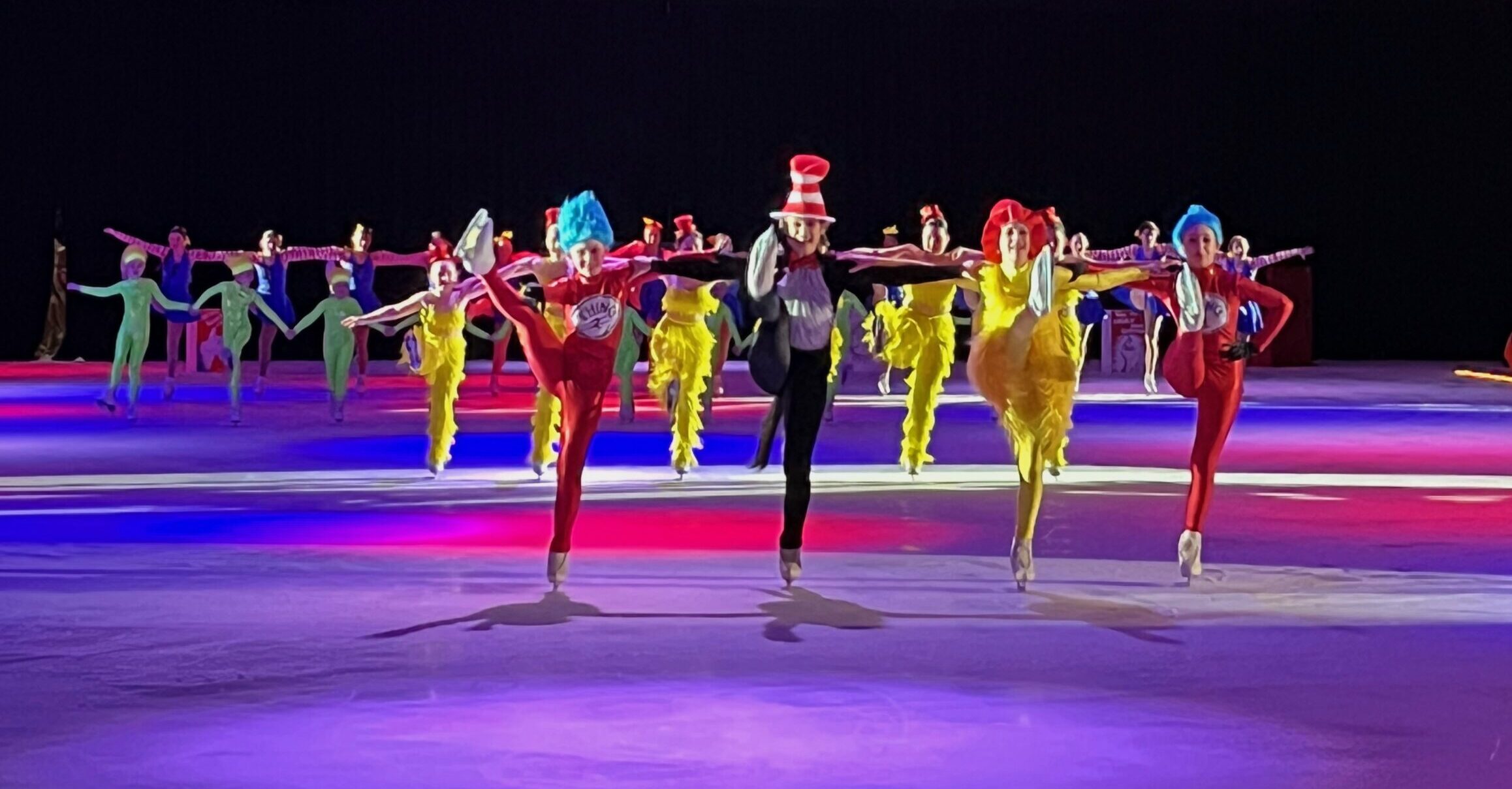 A Group of Skaters in Color Costume Performing on Ice