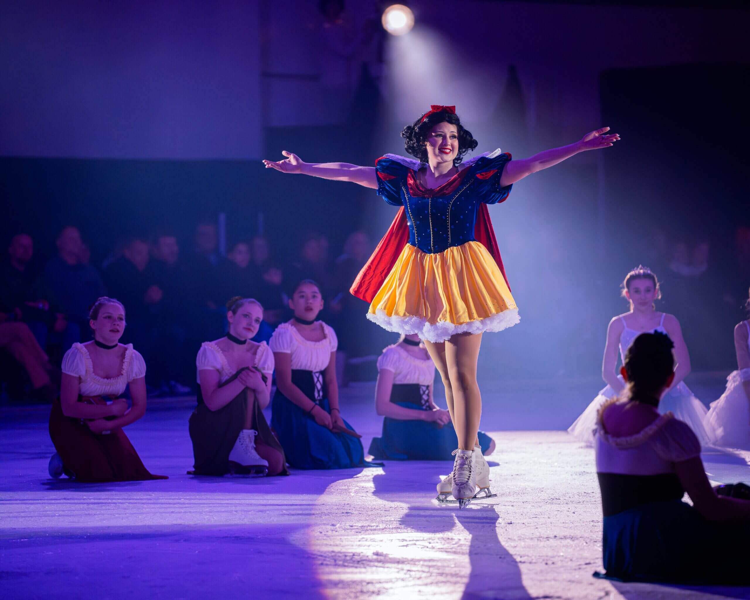 Snow White ice skating in costume.