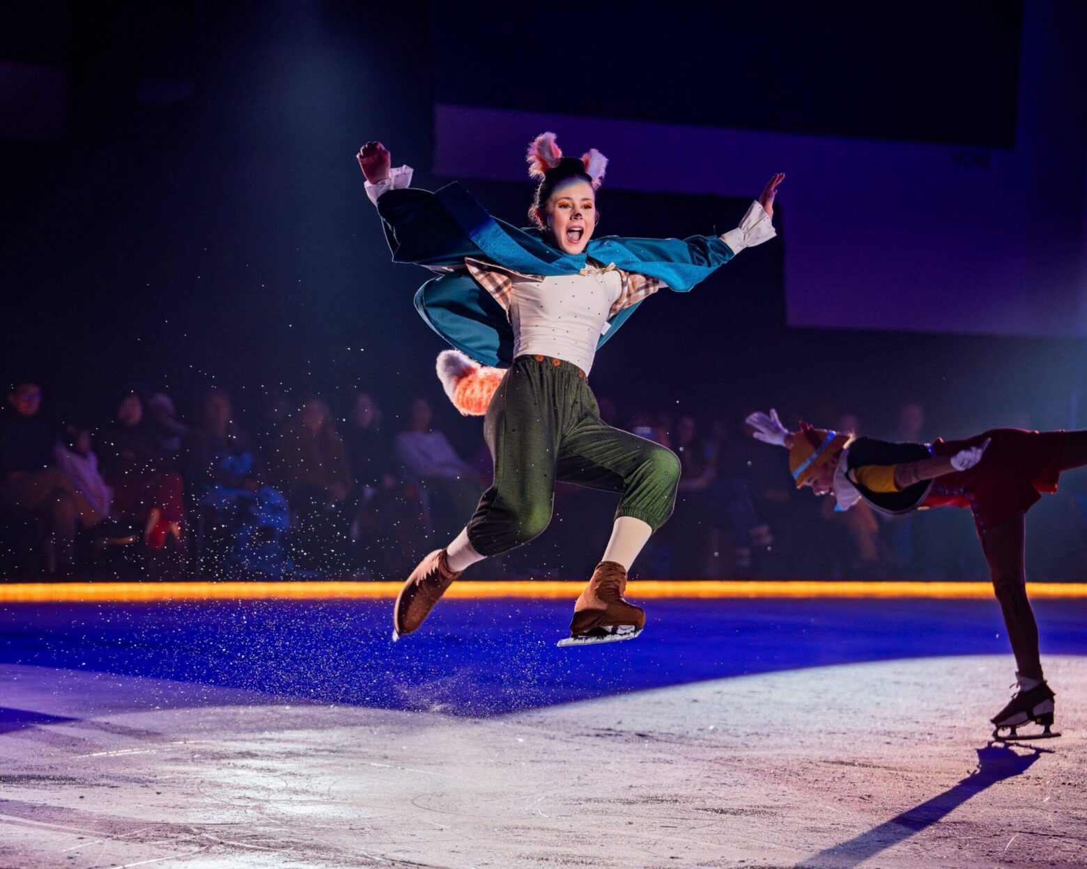 Woman ice skating in costume and ears.