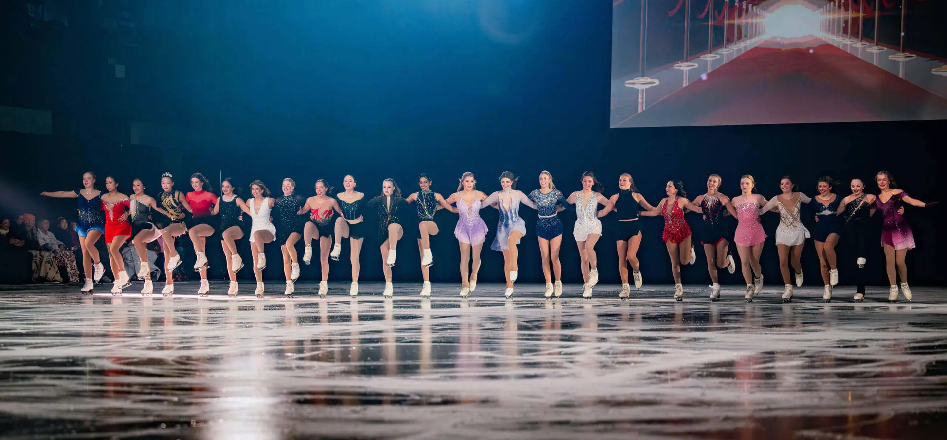 Group of figure skaters performing on ice.