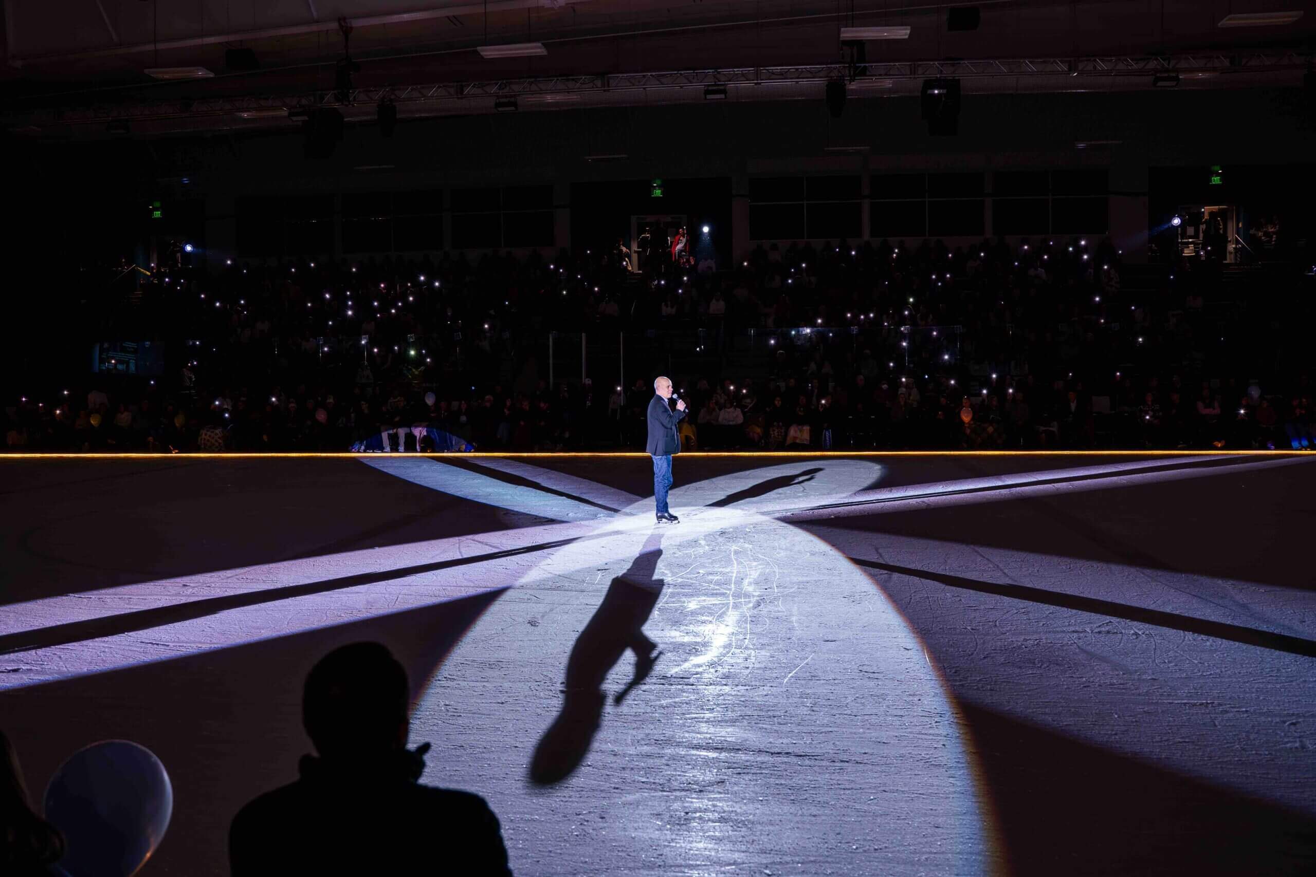 Singer performing on illuminated stage.