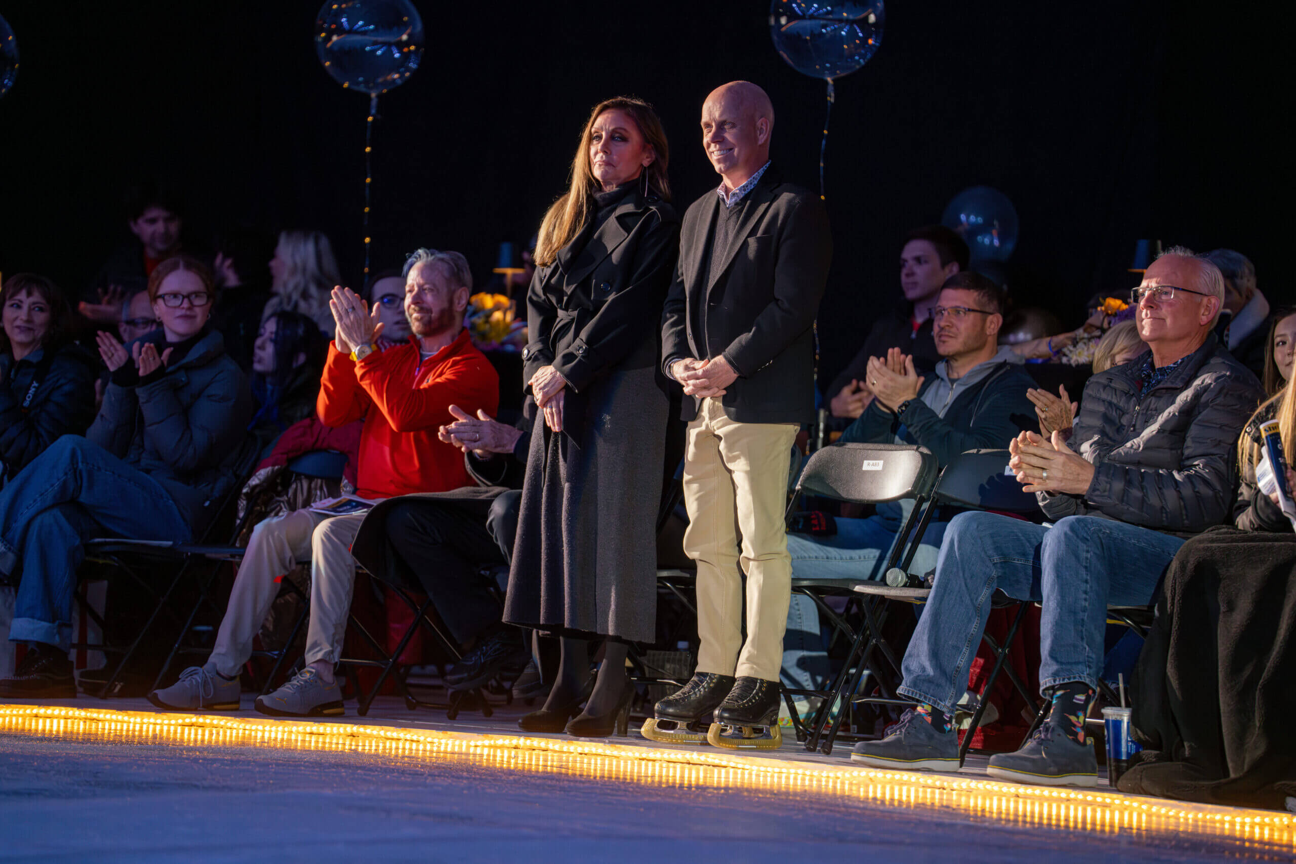 Audience applauding at an indoor event.